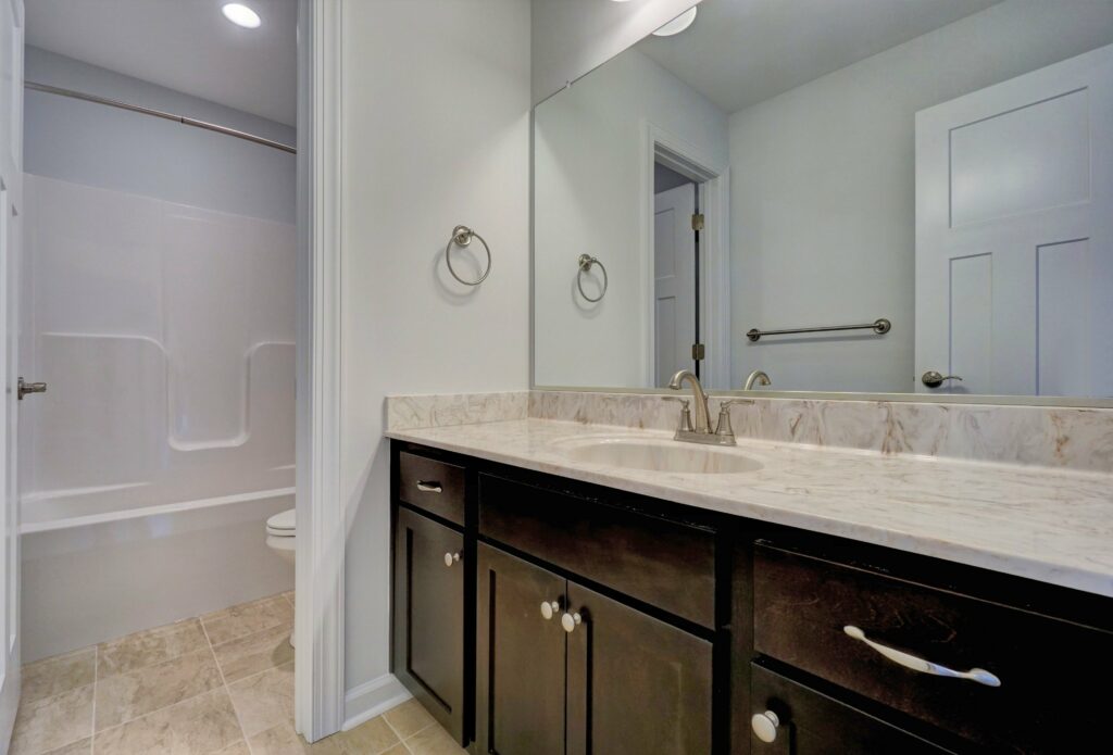 The Augusta Bathroom with Vanity with Dark Cabinets, and Separate Shower Tub, and Toilet