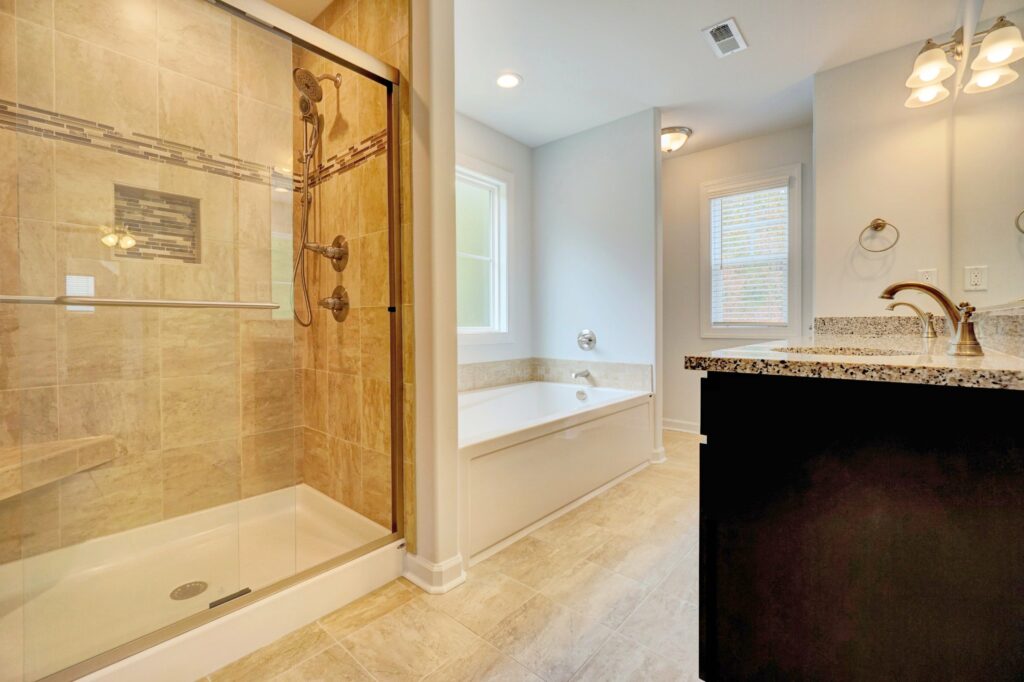 Home Builder in Smithfield VA. The Augusta Primary Bathroom with Double Sink Vanity, Shower, and Soaker Tub