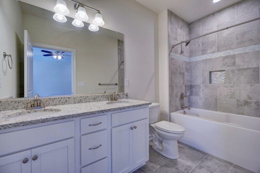 The Somerton III Primary Bathroom with Dual Vanity and Tub Shower