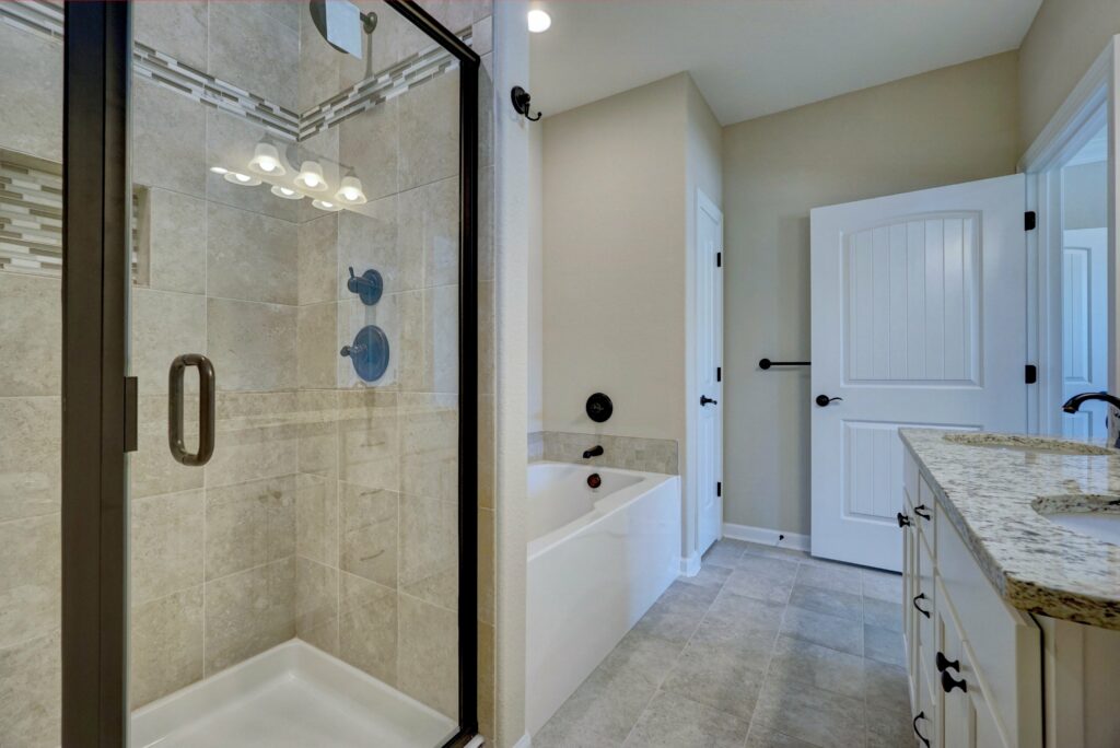 The Windsor Primary Bathroom with Shower, Soaker Tub, and Vanity