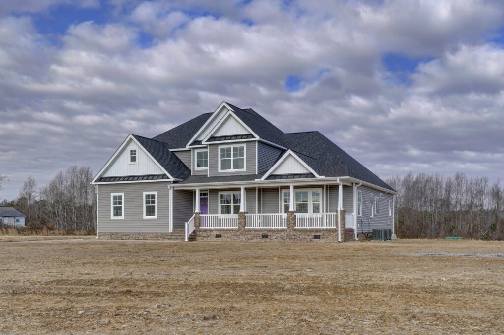 Where We Build. Where Does AB Homes Build. The Sussex Exterior Front Side Angle with Porch Grey with Purple Door